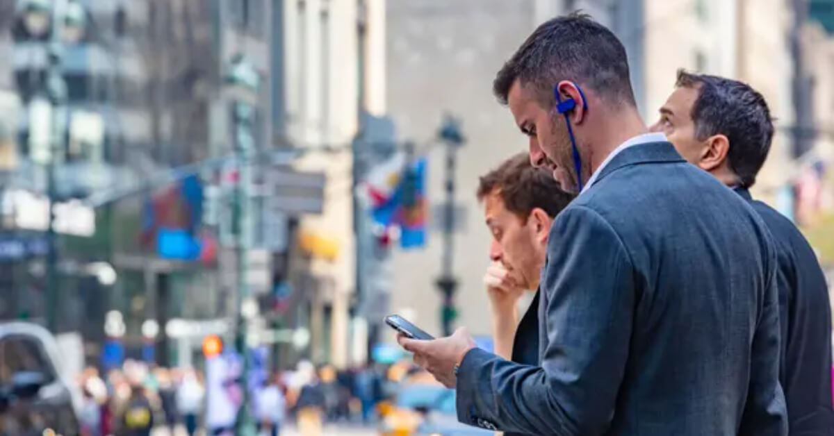 Male trader with mobile in hand